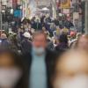 blurry crowd of people on the street wearing masks